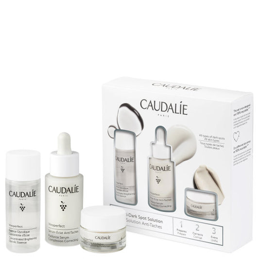 Caudalie Vinoperfect Brightening Solution Set with skincare bottles and tubes for reducing dark spots and evening skin tone.