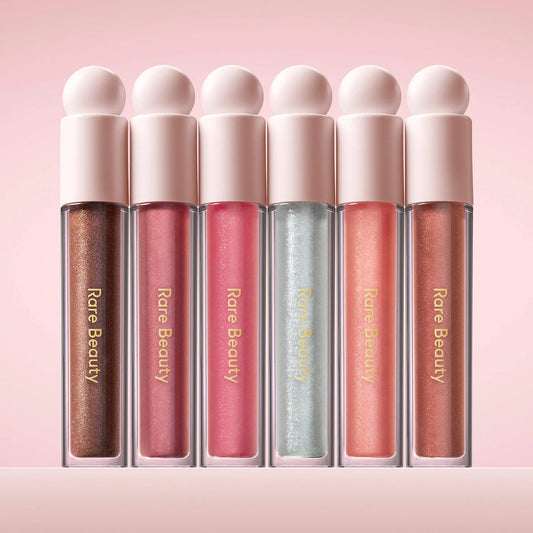 Rare Beauty Positive Light Luminizing Lip Gloss in various shades, featuring glossy, radiant finish and smooth application.