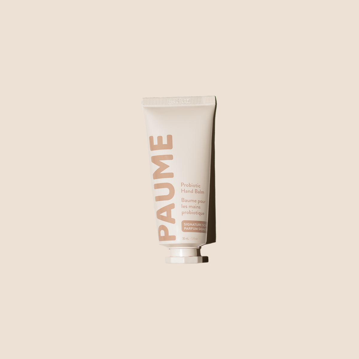 PAUME Probiotic Hand Balm in a sleek container, showing the luxurious beauty product designed for nourishing and hydrating hands.