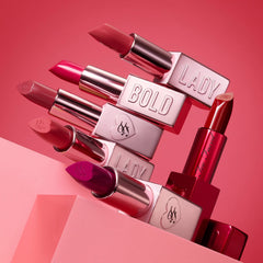 Too Faced Lady Bold Lipstick in various shades, featuring sleek packaging and vibrant colors, showcasing a beauty product for lips.