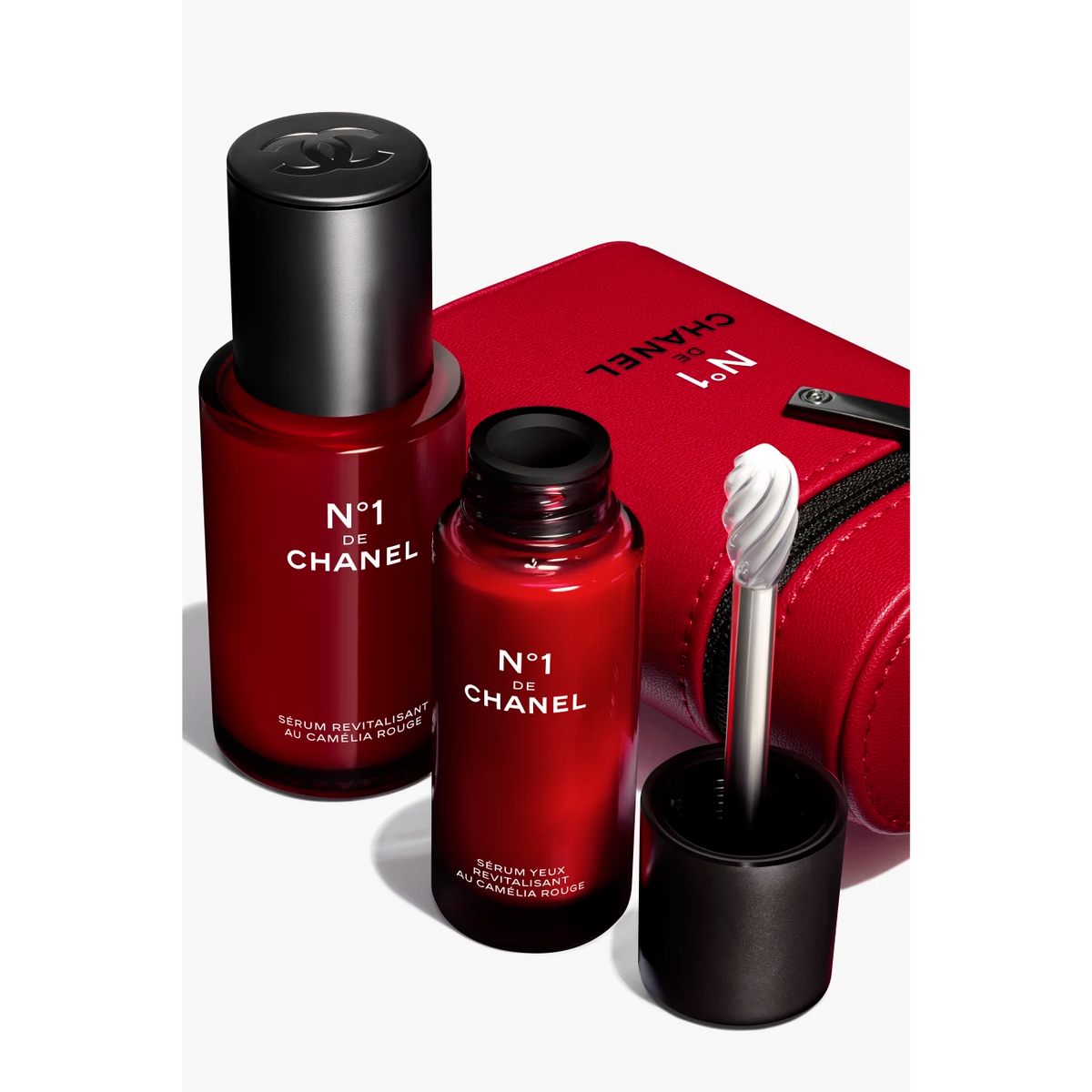 Chanel N°1 De Chanel Red Camellia Expert Revitalizing Serum Duo bottles with red camellia flower design, for skincare rejuvenation.