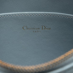 Dior medium calfskin Cannage Caro Daily Pouch in blue with quilted design and gold-tone hardware, shown with its front view.