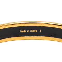Hermès narrow enamel fruits cloisonné bangle featuring colorful fruit designs on a gold-tone jewelry bracelet
