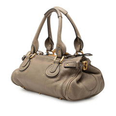 Chloé Medium Leather Paddington Handbag in neutral tones, showcasing its structured design, top handle, and signature hardware.