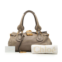 Chloé Medium Leather Paddington Handbag in beige with gold hardware, featuring top handles and a structured design.