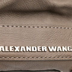 Brown Alexander Wang Leather Fold Over Trunk Adele Clutch bag with sleek design and fold-over flap, styled for elegant occasions.