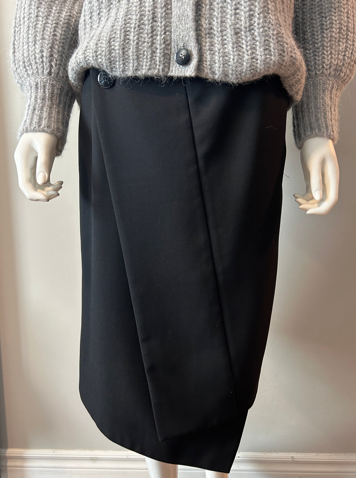 Black Acne asymmetrical hoist skirt in size 38/6, featuring a modern, edgy design with uneven hem and tailored fit.