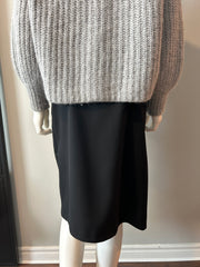 Acne black hoist skirt in size 38/6, featuring an asymmetrical design and stylish fit, displayed on a hanger.