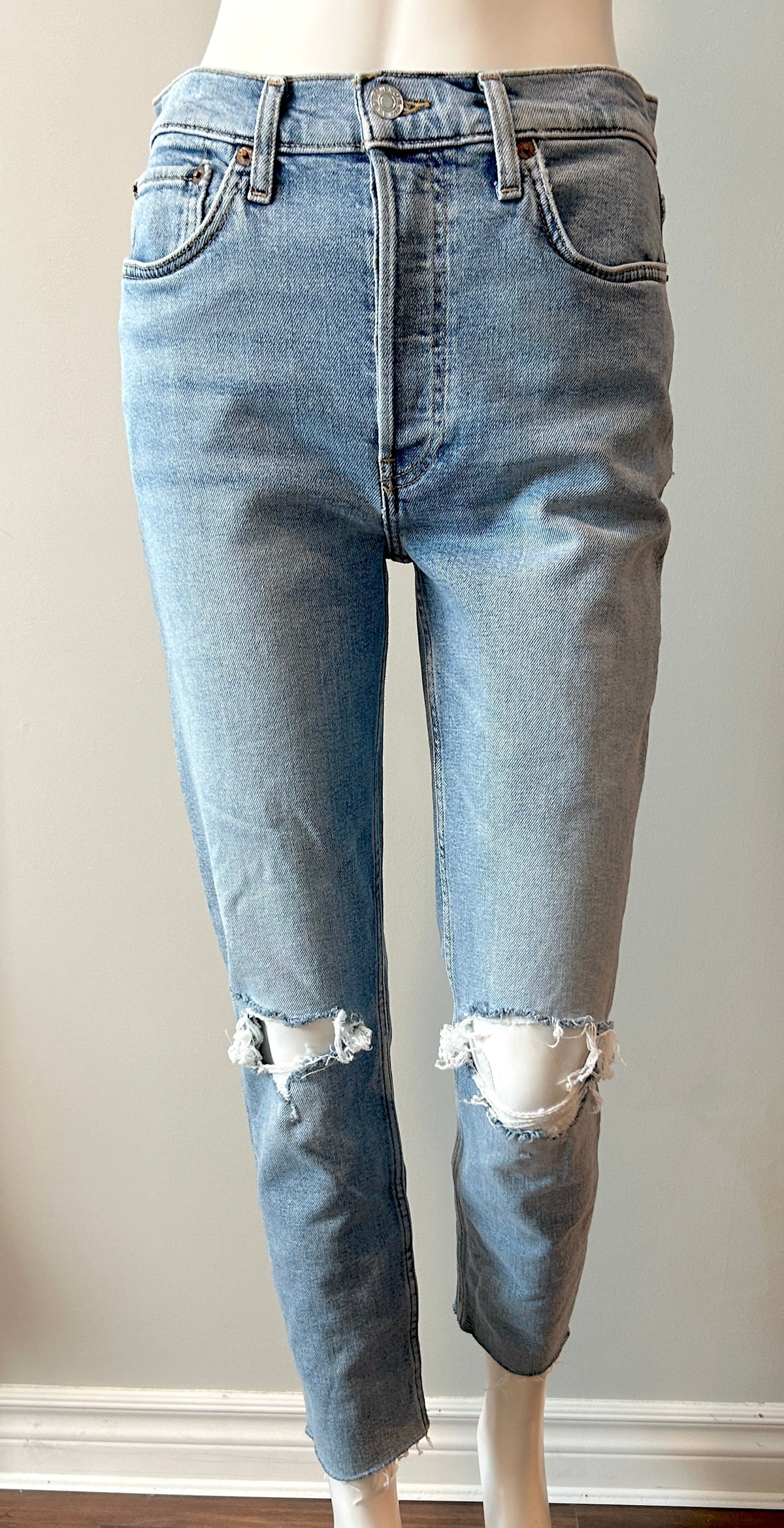 Re/Done 90s high-rise ankle crop jeans in size 28, showing light wash denim with distressed hem and classic five-pocket design.