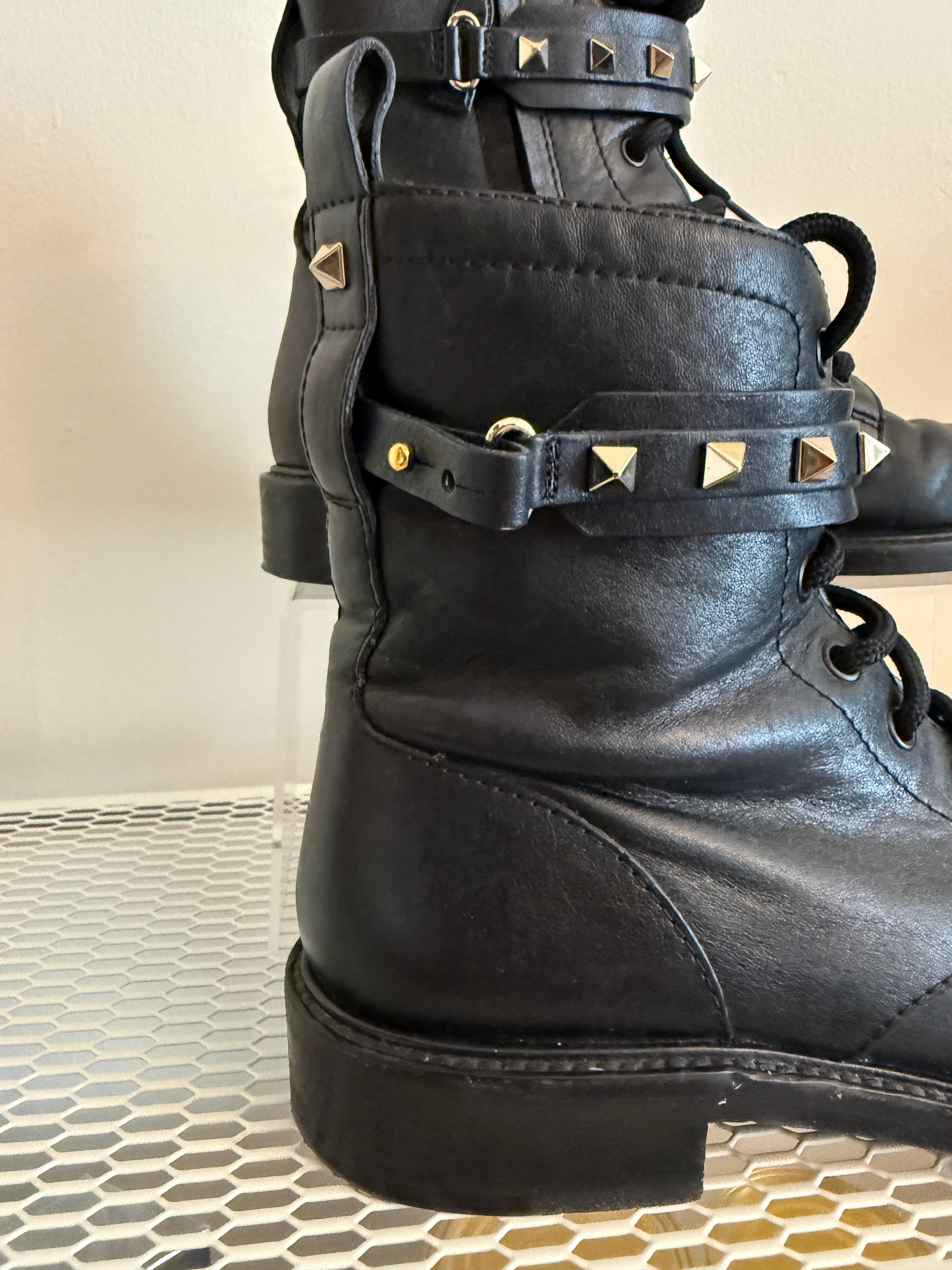 Valentino Rock Stud Combat Boots in size 38.5, featuring black leather with signature stud embellishments and rugged combat style.