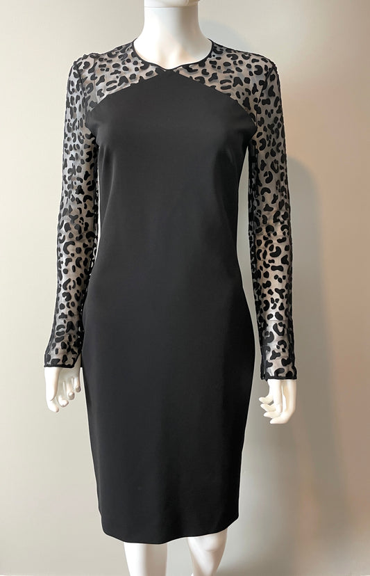 Stella McCartney mini dress in size IT44/US6, elegant black clothing with stylish design, displayed on a hanger.