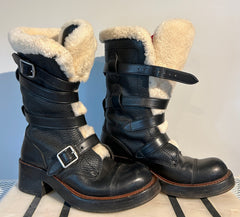 Coach shearling moto boots in size 6.5, featuring black leather and cozy shearling lining, displayed on a neutral background.