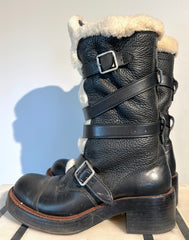 Coach shearling moto boots size 6.5, featuring black leather and cozy shearling lining, displayed on a white background.