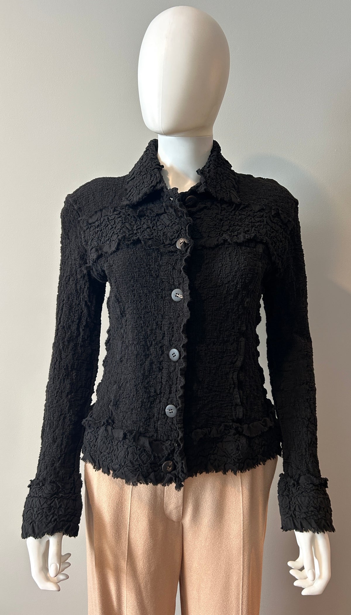 Issey Miyake blazer size 6, stylish clothing with a tailored fit, shown in a close-up image highlighting the fabric and design details.