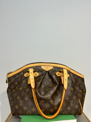 Louis Vuitton Monogram Tivoli GM bag with leather straps and monogram canvas, featuring gold-tone hardware and top handles.