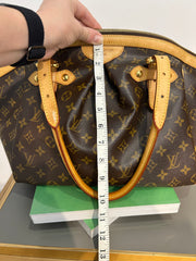 Louis Vuitton Monogram Tivoli GM bag with leather handles and spacious interior, featuring iconic LV monogram canvas.