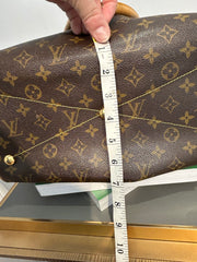 Louis Vuitton Monogram Tivoli GM bag with leather handles and gold hardware, featuring the classic LV monogram canvas.