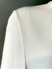 Fendi cream blouse size 40/6, featuring elegant fabric and classic design, displayed on a hanger against a neutral background.