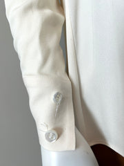 Fendi cream blouse size 40/6, elegant clothing with a soft, flowing fabric and classic design, displayed on a hanger.