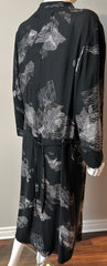 Raquel Allegra XL graphic print dress hanging on a wooden hanger, featuring bold patterns and a relaxed, stylish silhouette.