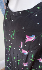 Rixo Georgia silk skirt in size S, featuring flowing fabric and stylish design, displayed on a hanger against a neutral background.