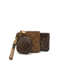 Louis Vuitton Monogram Reverse Giant Trio Pouch Set showing three elegant SLG pouches with signature monogram pattern and leather accents.