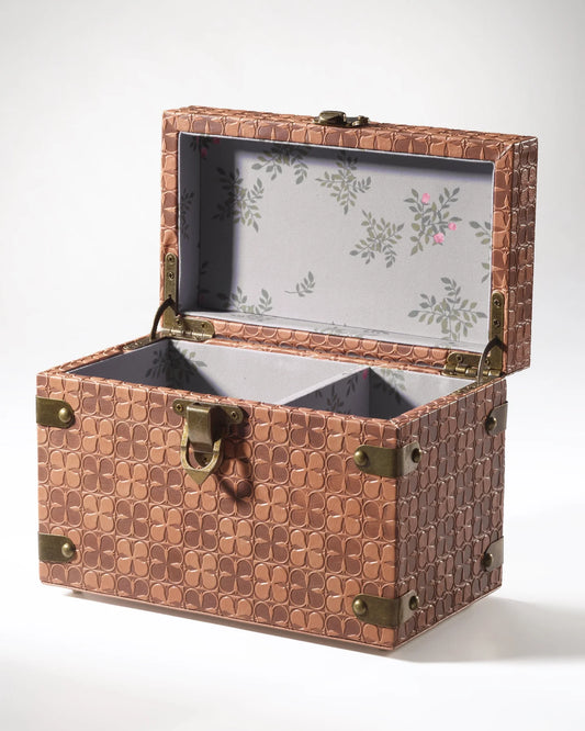 The Maker leather jewelry box with a sleek, compact design, featuring multiple compartments and a rich brown leather finish.