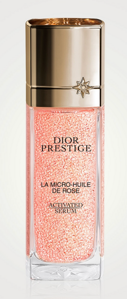 Dior Prestige La Micro-Huile de Rose activated serum bottle alongside the Prestige Le Pétale massage tool set for skincare.