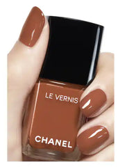 Chanel Vernis nail color bottles in various shades, showcasing sleek glass packaging and colorful polish options.