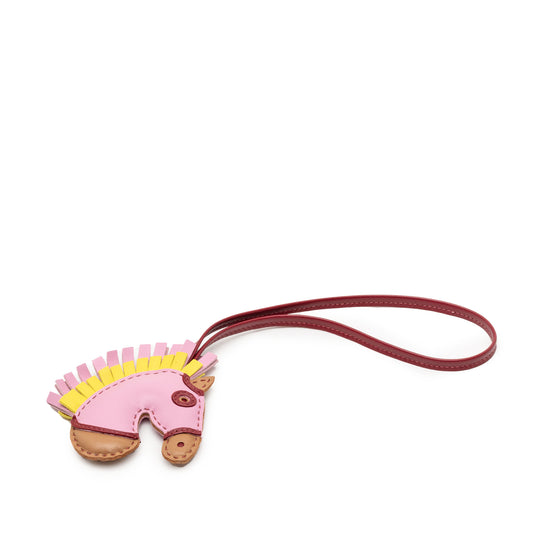 Hermès Milo Lambskin Geegee Camail bag charm in pink, featuring soft lambskin material and intricate detailing.