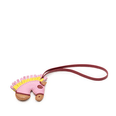 Hermès Milo Lambskin Geegee Camail bag charm in pink, featuring soft lambskin material and intricate detailing.