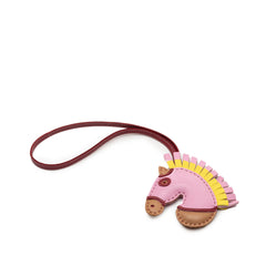 Hermès Milo Lambskin Geegee Camail Bag Charm in pink, featuring soft lambskin leather and detailed accessory design.