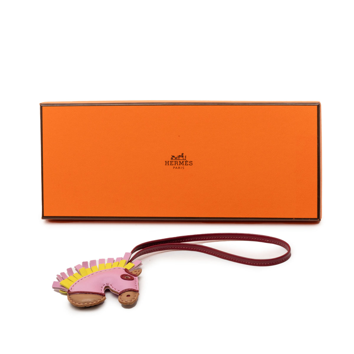 Hermès Milo Lambskin Geegee Camail Bag Charm in pink, featuring soft lambskin leather and detailed accessory design.