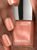 Chanel Vernis nail color in shimmering gold shade, new in box, showcasing glossy finish and elegant packaging for beauty and nail care.
