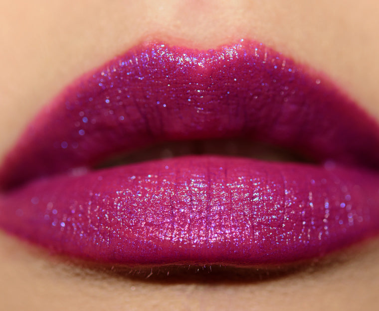 MAC x Teyana Taylor beauty product with two shades, featuring lip swatches on a model's lips showcasing vibrant lipstick colors.