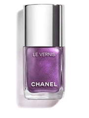 Chanel Vernis nail color bottles in various shades, showcasing sleek glass packaging and colorful nail polish inside.