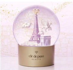 Clé de Peau Beauté Holiday Limited Edition Snow Globe featuring elegant design and festive scene, new in box.