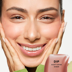 Saie Glossybounce™ high-shine hydrating lip gloss oil in a clear tube with a doe-foot applicator, showcasing a glossy finish.