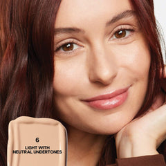 Saie Slip Tint Radiant All-Over Concealer in multiple shades, displayed with packaging and swatches on a neutral background.