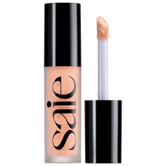 Saie Slip Tint Radiant All-Over Concealer in various shades, showing smooth, lightweight formula in a sleek container.
