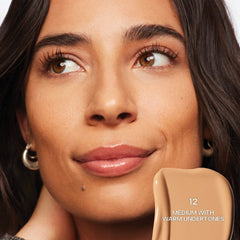 Saie Slip Tint Radiant All-Over Concealer in multiple shades, natural finish, tube packaging, close-up view of the concealer.