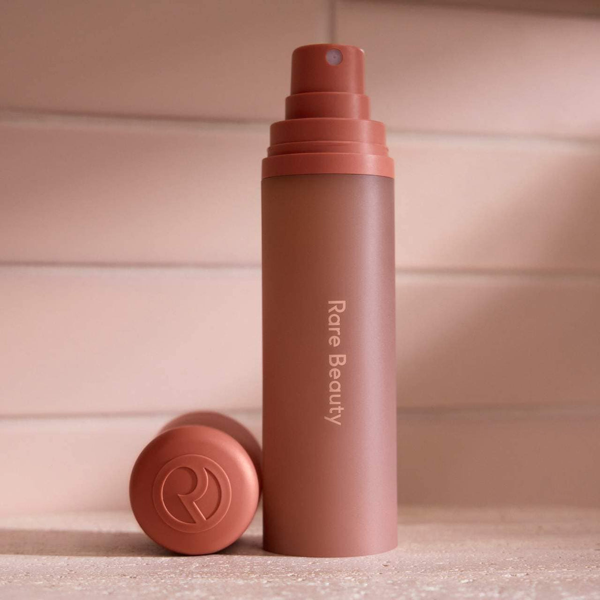Rare Beauty Find Comfort body and hair fragrance mist with Niacinamide, NWOB, featuring sleek packaging and a refreshing spray nozzle.