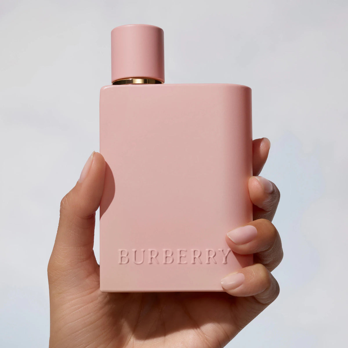Burberry Her Parfum 100ml bottle, elegant glass container with gold accents, displayed in a beauty product image.