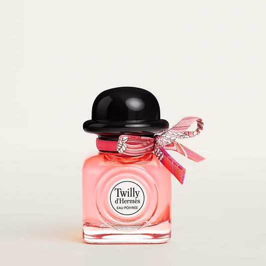 Hermès Twilly Eau Poivre 30ml NIB perfume bottle with vibrant pink ribbon and elegant packaging, showcasing the luxury fragrance.